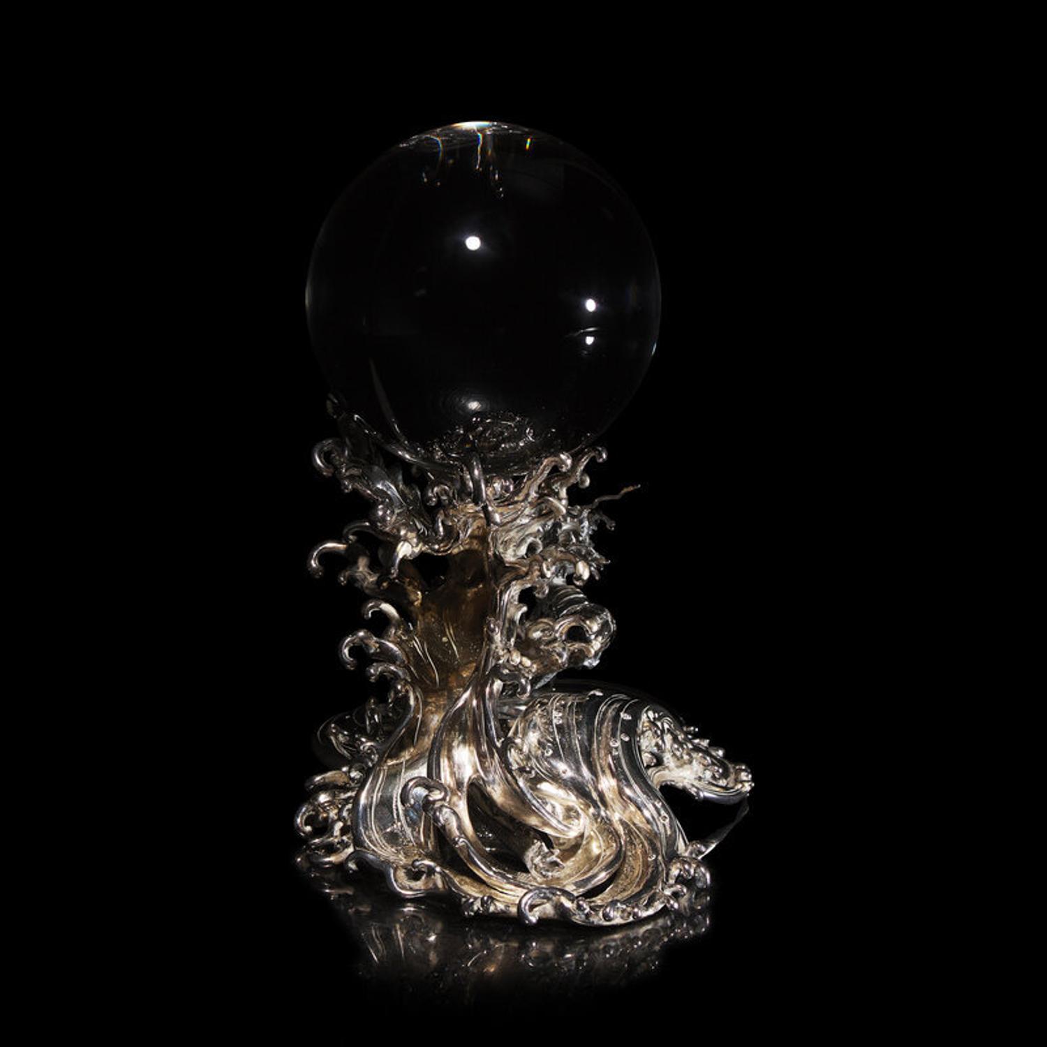 A Japanese Rock Crystal Sphere and Silver 'Dragon and Waves' Stand, Signed Yoshimasa Saku Meiji/Taisho Period 日本明治/大正時期 義正作潮を支配する珠と龍