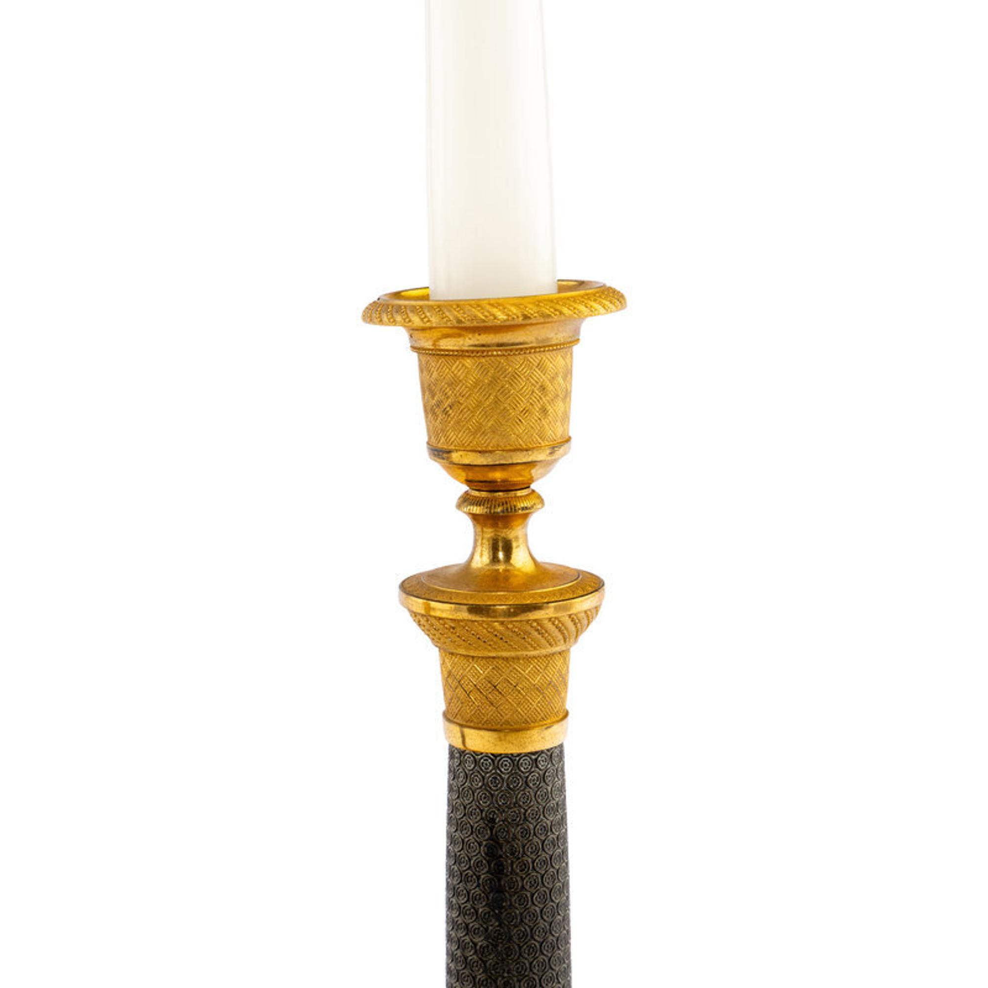 A Pair of Continental Gilt and Patinated Bronze Candlesticks