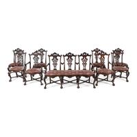 An Italian Rococo Style Carved Mahogany Nine-Piece Seating Suite