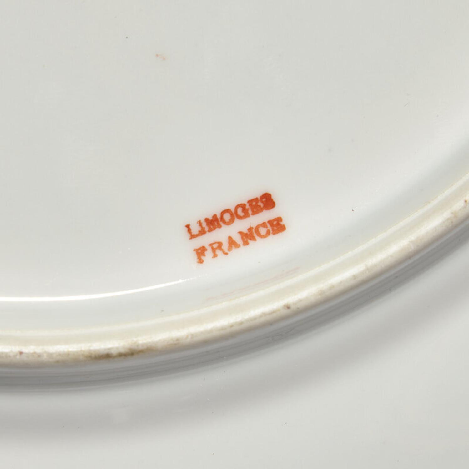 A Set of Twelve Limoges Porcelain Chargers