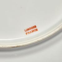 A Set of Twelve Limoges Porcelain Chargers