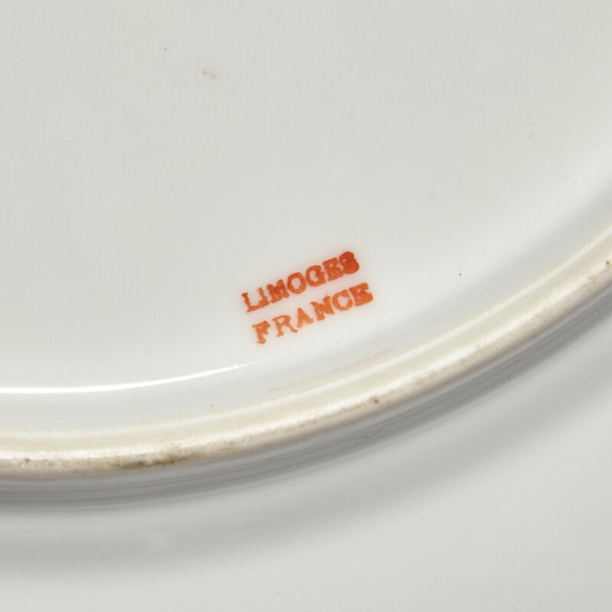 A Set of Twelve Limoges Porcelain Chargers