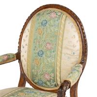 A Pair of Louis XVI Carved Walnut Fauteuils