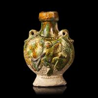 A Chinese Molded Sancai-Glazed Pottery Pilgrim Flask, Tang Dynasty 唐 三彩模印樂舞圖雙繫扁壺