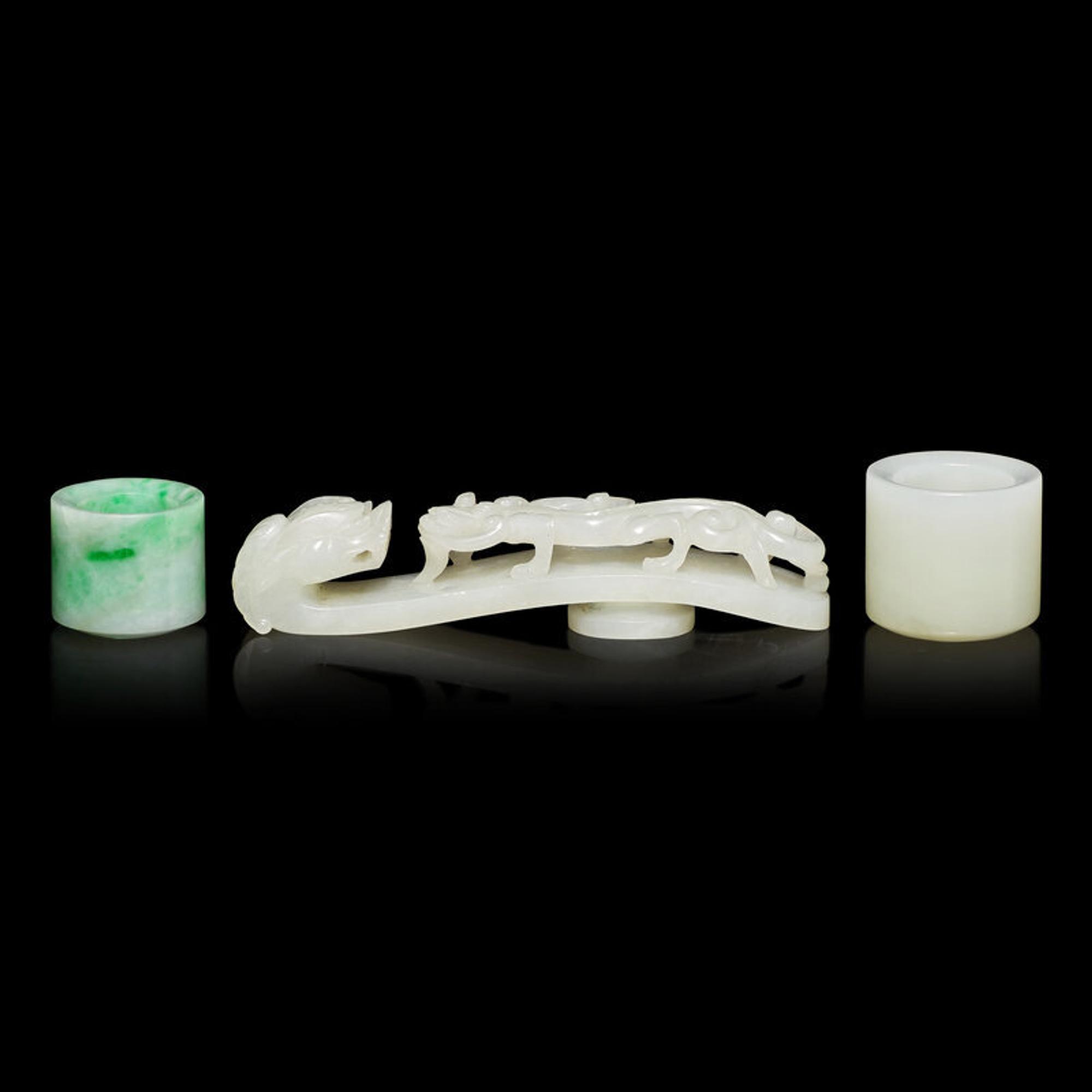 Two Chinese Jade and Jadeite Archer's Rings and a Jade 'Dragon' Belt Hook, Qing Dynasty 清 白玉、翡翠扳指及龍鈎一組三件