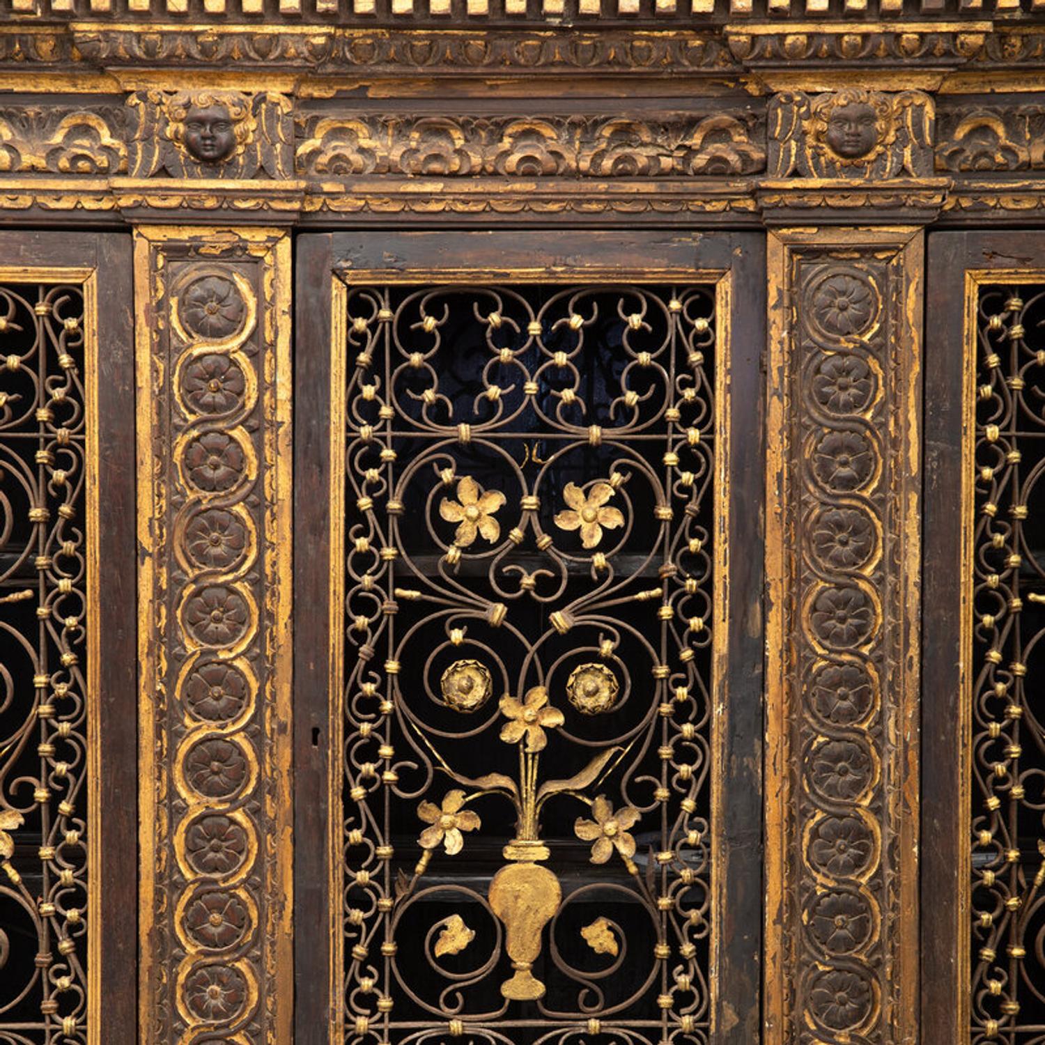 An Italian Iron-Mounted and Parcel Gilt Bookcase Supplied by Addison Mizner for the Everglades Club, Palm Beach