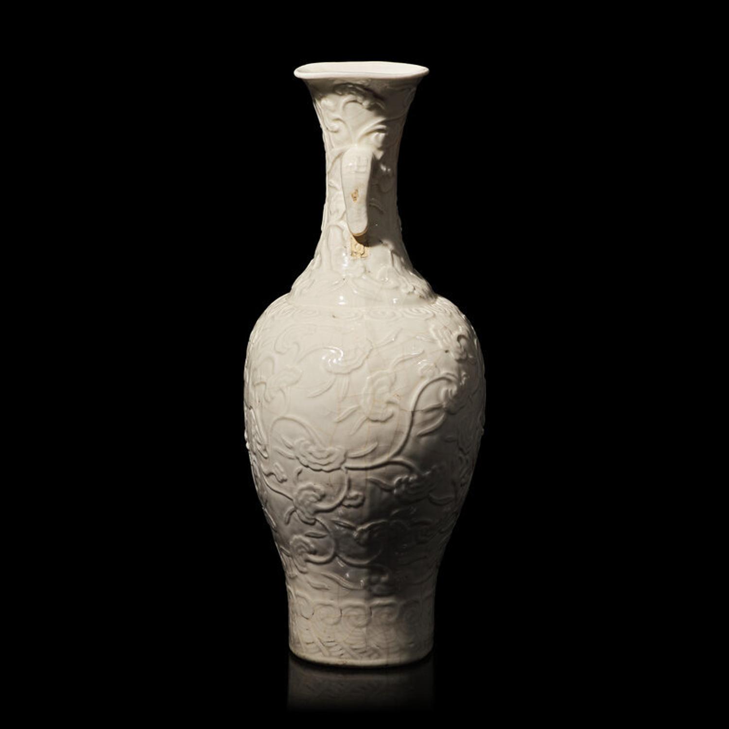 A Chinese White Glazed Soft Paste Molded 'Dragons and Lingzhi' Vase, 18th Century 清中期 白釉模印漿胎靈芝螭龍紋瓶
