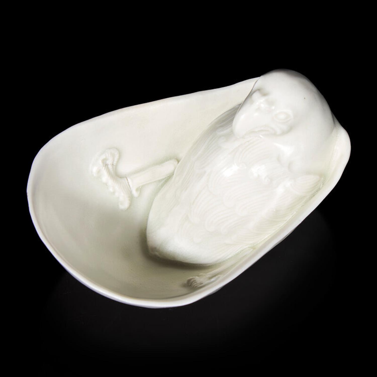 A Chinese Transparent Glazed 'Parrot' Cup, Song Dynasty 宋 白瓷鸚鵡杯