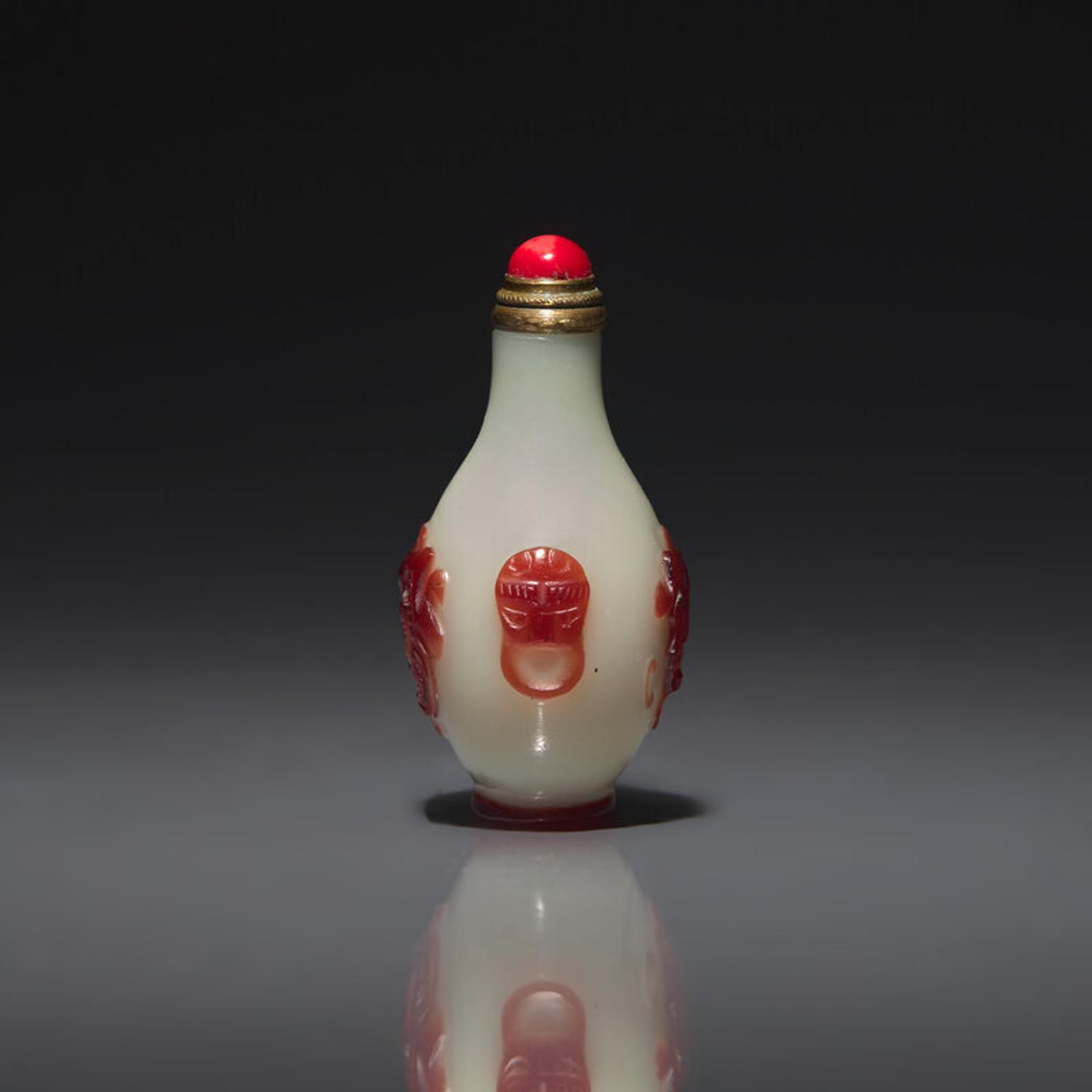 A Chinese Miniature Red-Overlaid Opaline Glass Snuff Bottle, Circa 1750-1820 1750-1820年 涅白地套寶石紅料螭龍紋小鼻烟壺