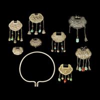 A Chinese Silver Necklace and Eight Chinese Silver Ruyi Lock-Form Pendants, Qing Dynasty 清 銀項圈一及銀如意頭形長命鎖一組八件