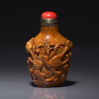 A Chinese Bird and Flower-Carved Root Amber Snuff Bottle 琥珀雕花鳥鼻烟壺