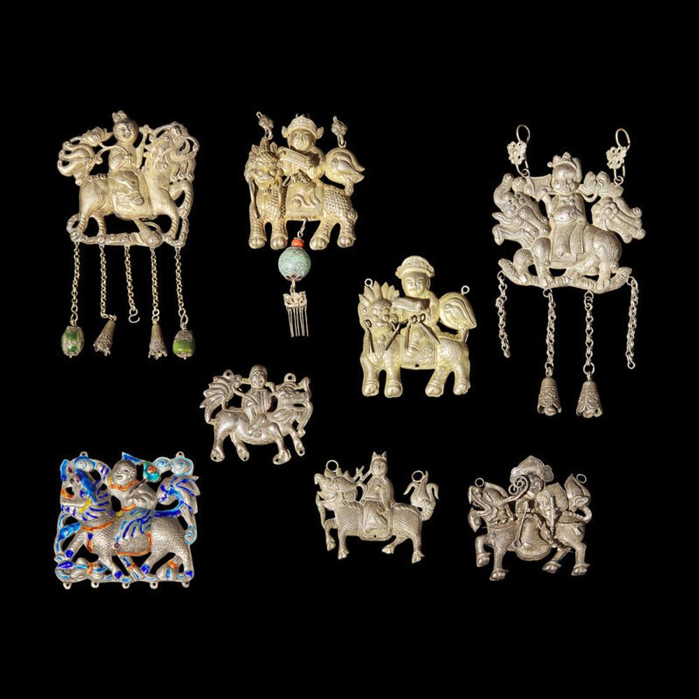 Eight Chinese Silver 'Boy and Qilin' Pendants, Late Qing Dynasty-Republic Period 晚清-民國 銀鍍金、銀燒藍及銀製麒麟送子長命鎖一組八件