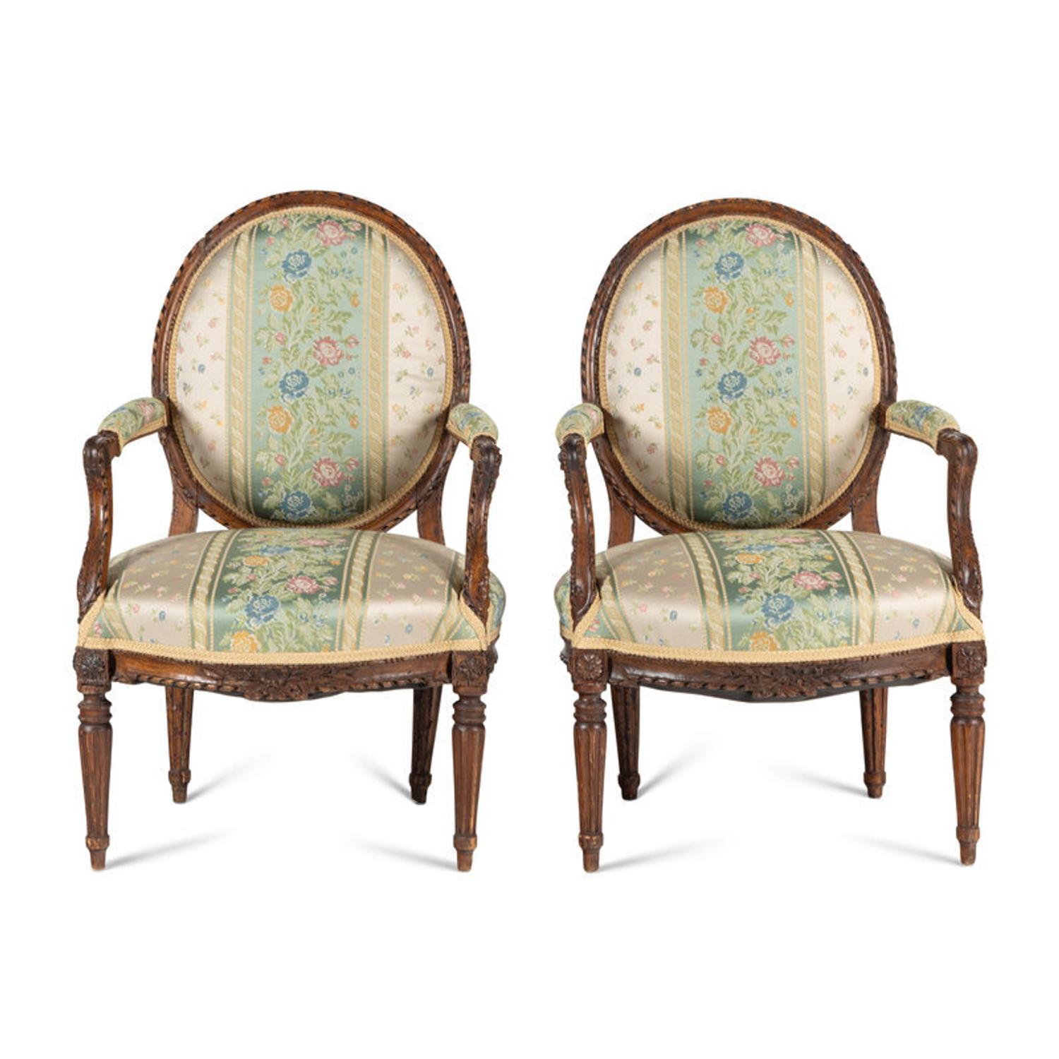 A Pair of Louis XVI Carved Walnut Fauteuils