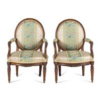 A Pair of Louis XVI Carved Walnut Fauteuils