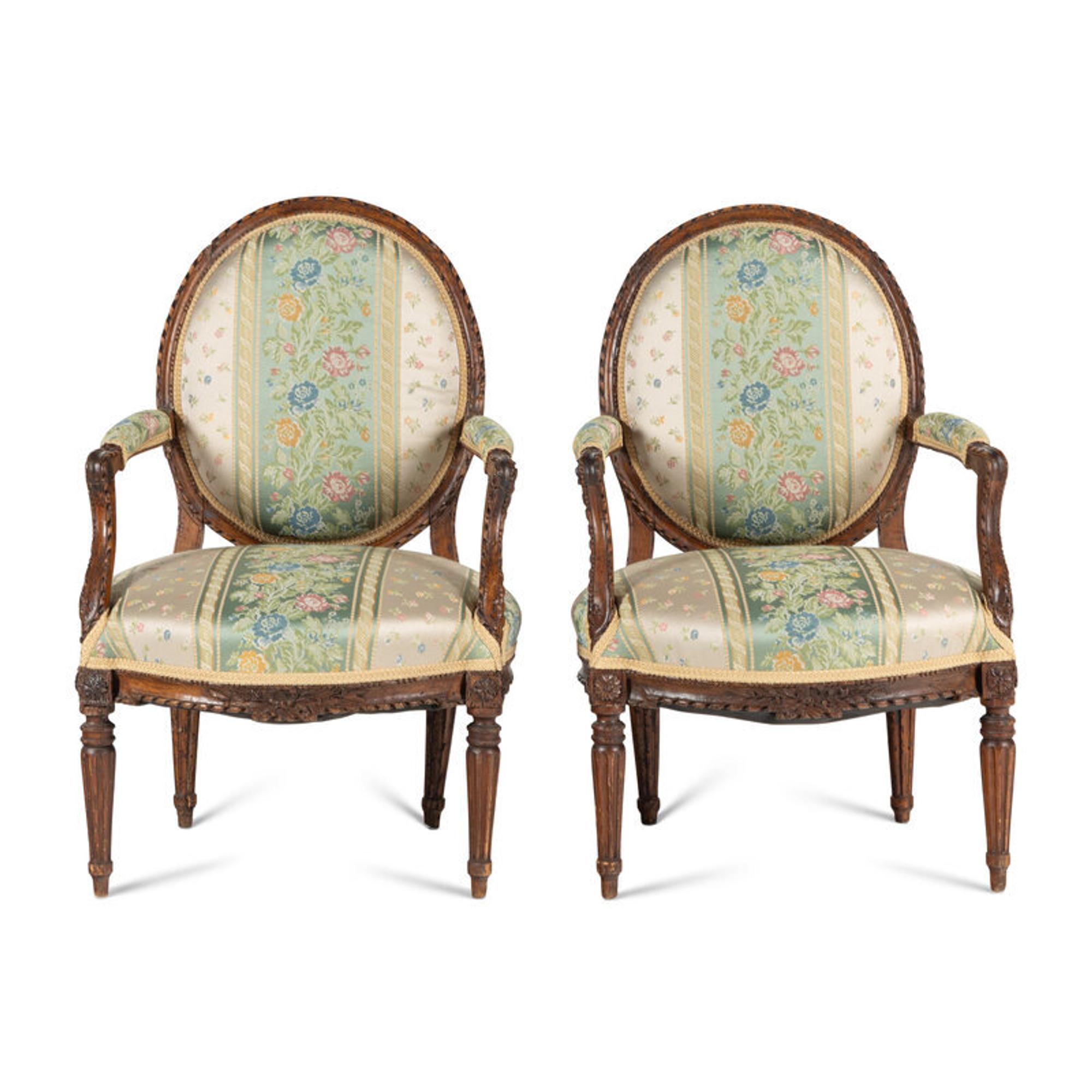 A Pair of Louis XVI Carved Walnut Fauteuils