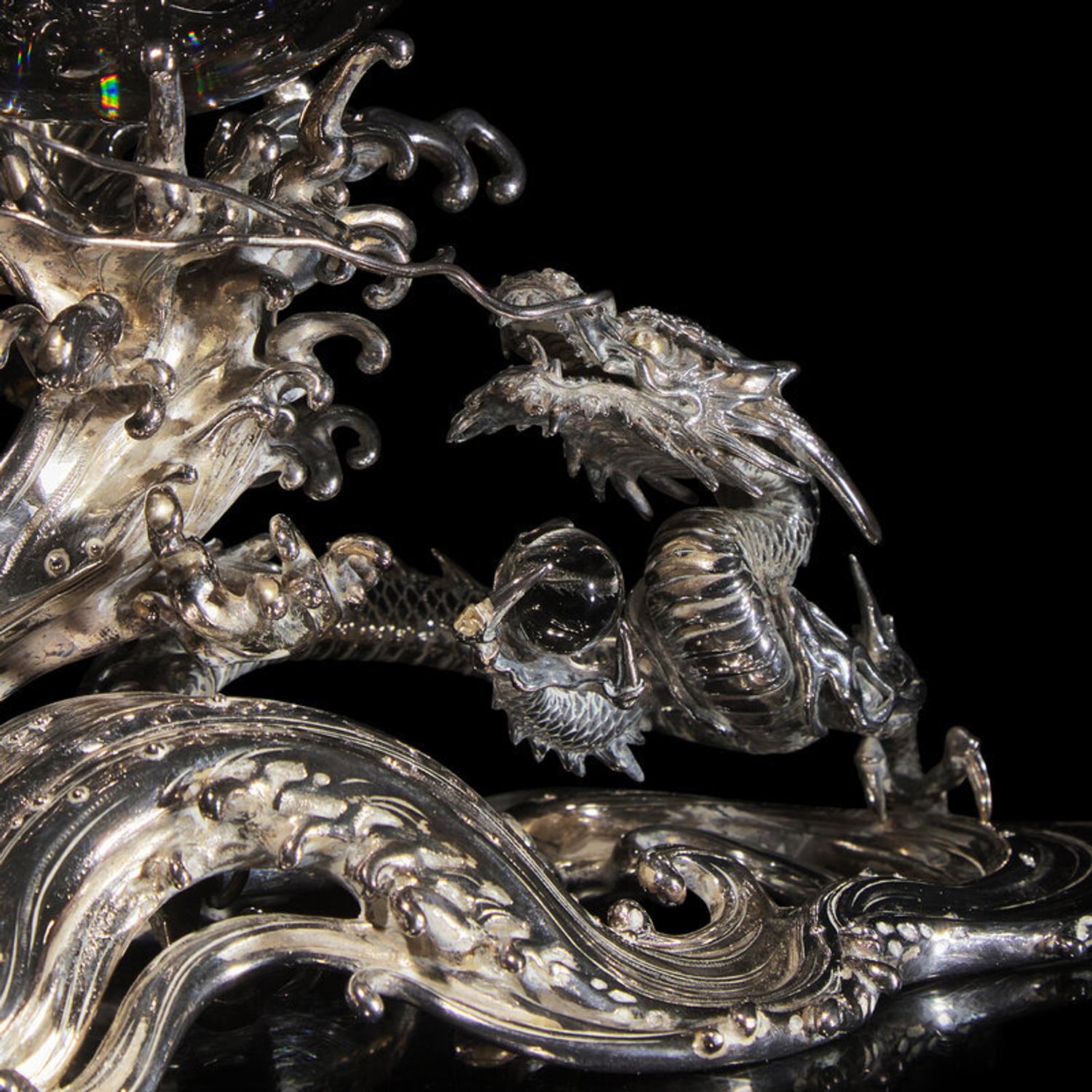 A Japanese Rock Crystal Sphere and Silver 'Dragon and Waves' Stand, Signed Yoshimasa Saku Meiji/Taisho Period 日本明治/大正時期 義正作潮を支配する珠と龍