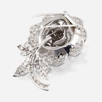 A diamond, yellow diamond, and platinum rose brooch