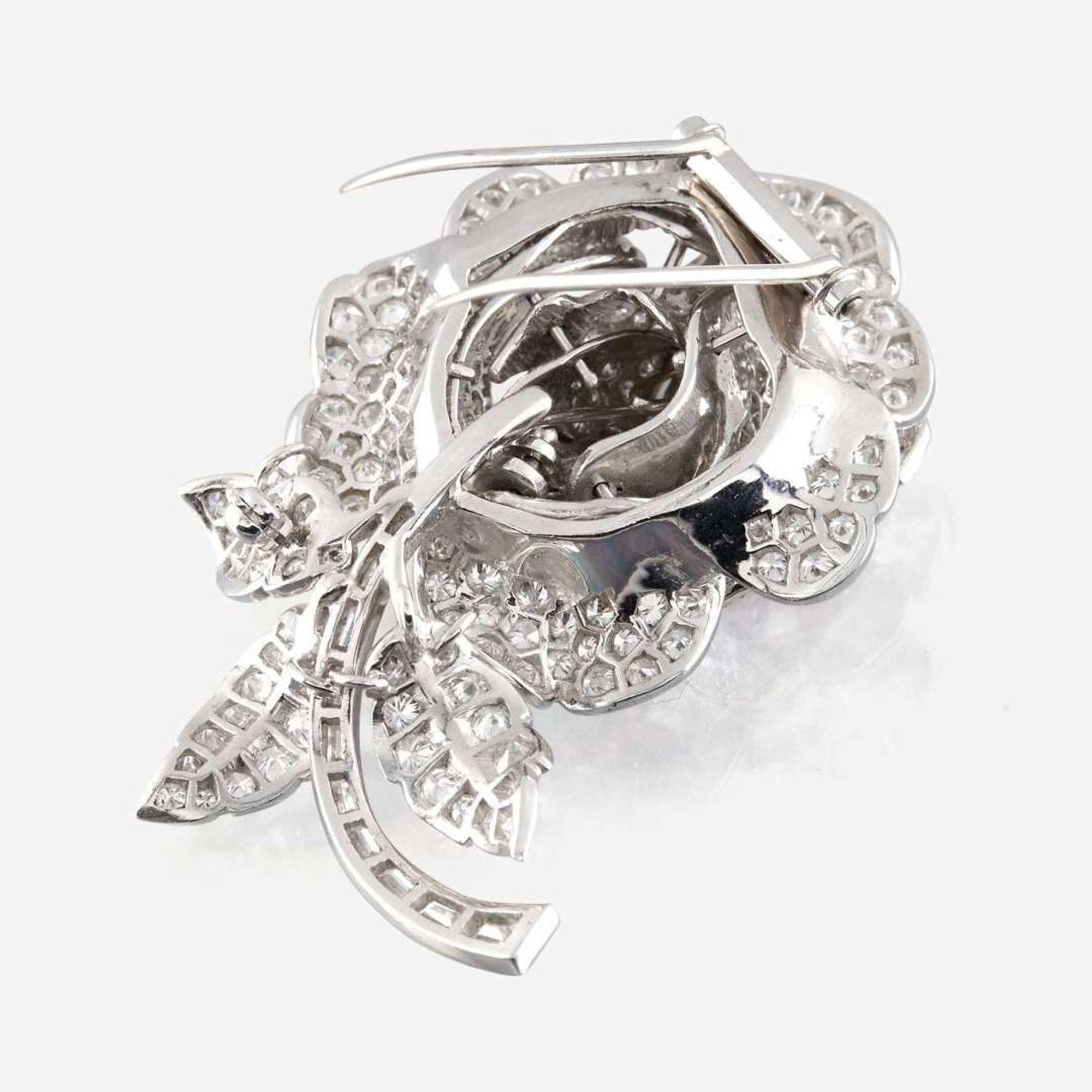 A diamond, yellow diamond, and platinum rose brooch
