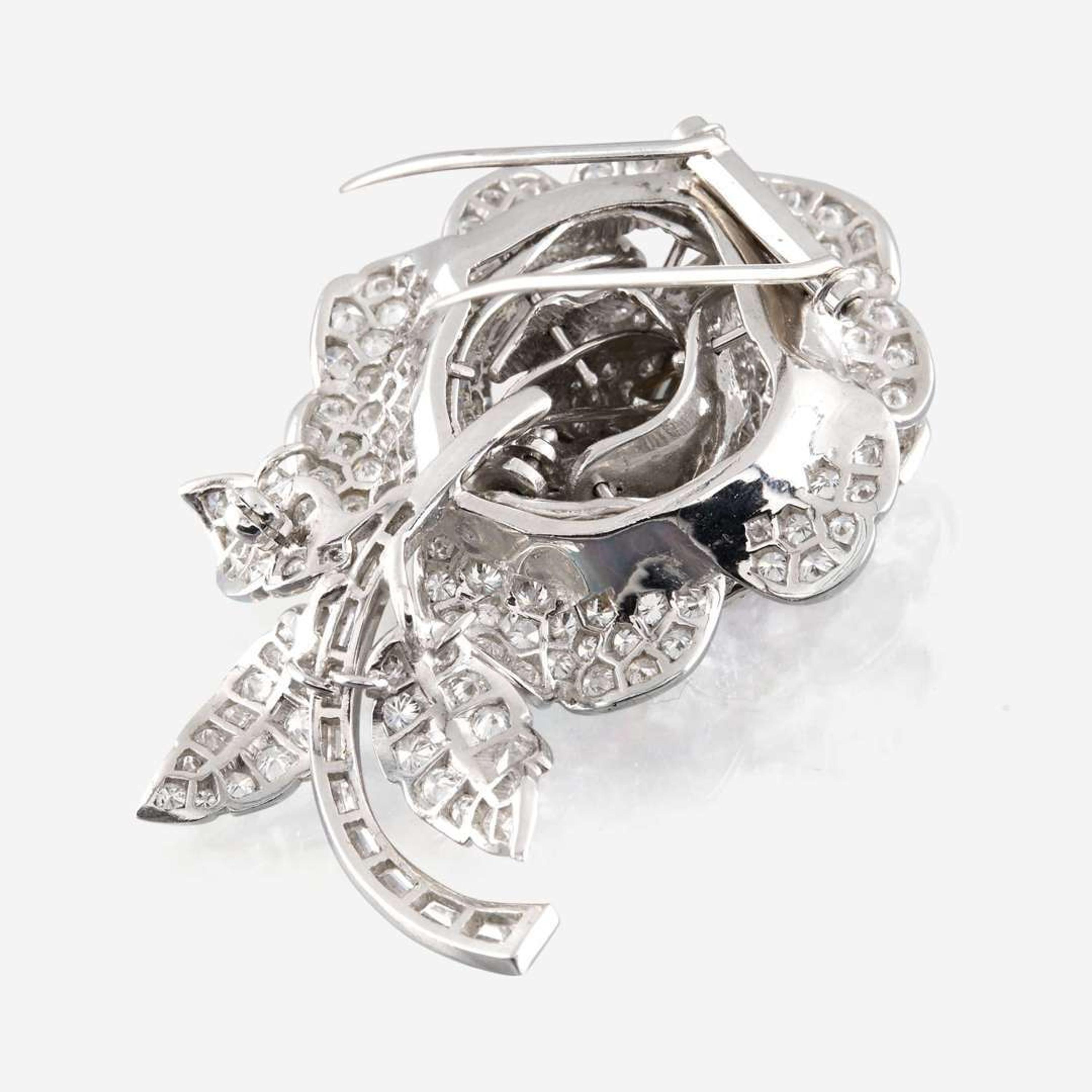 A diamond, yellow diamond, and platinum rose brooch