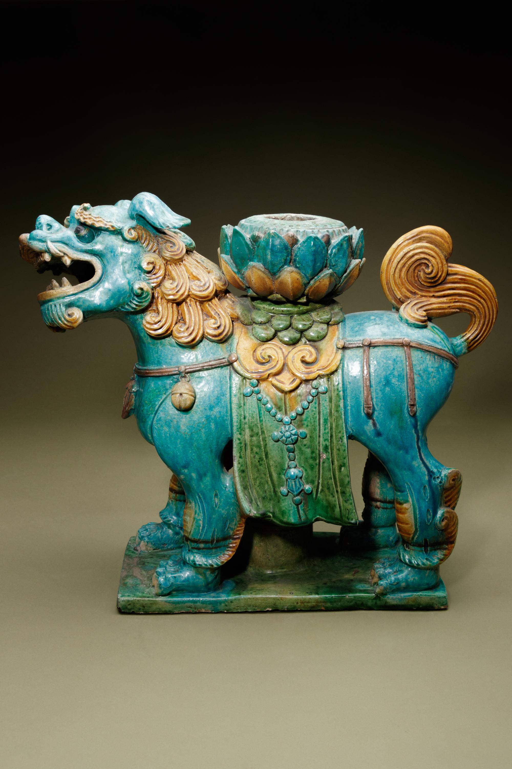 A Turquoise, Ochre and Green Glazed Tileworks 'Fu Lion' Stand