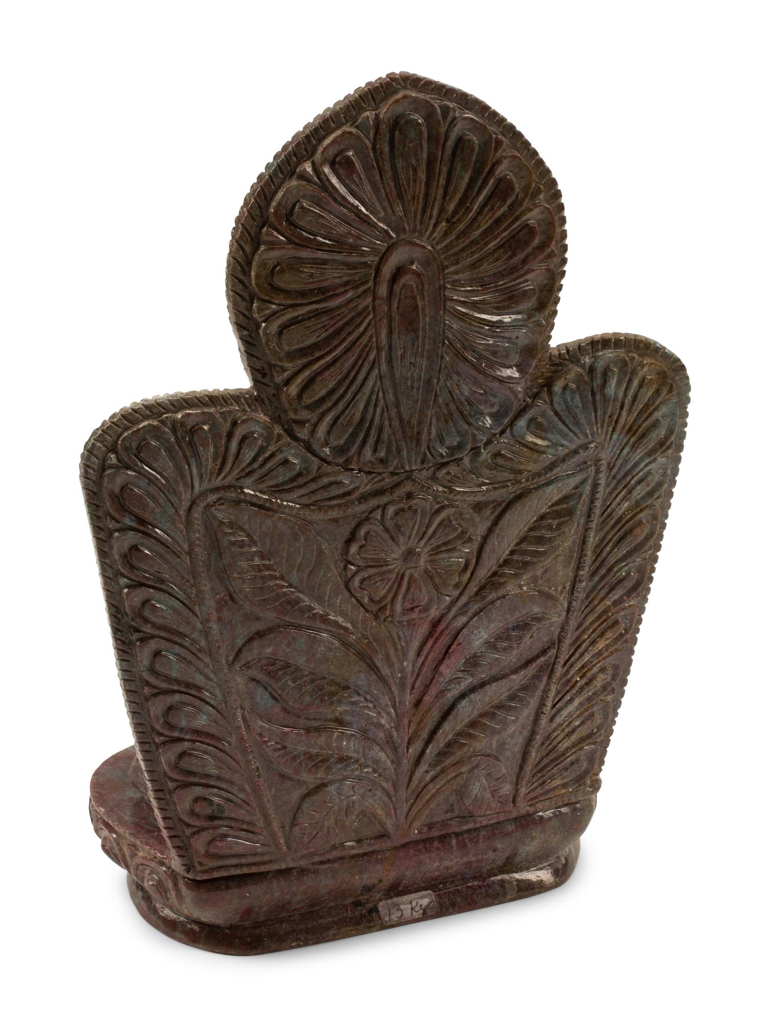 A Carved Ruby-Zoisite Figure of a Seated Deity