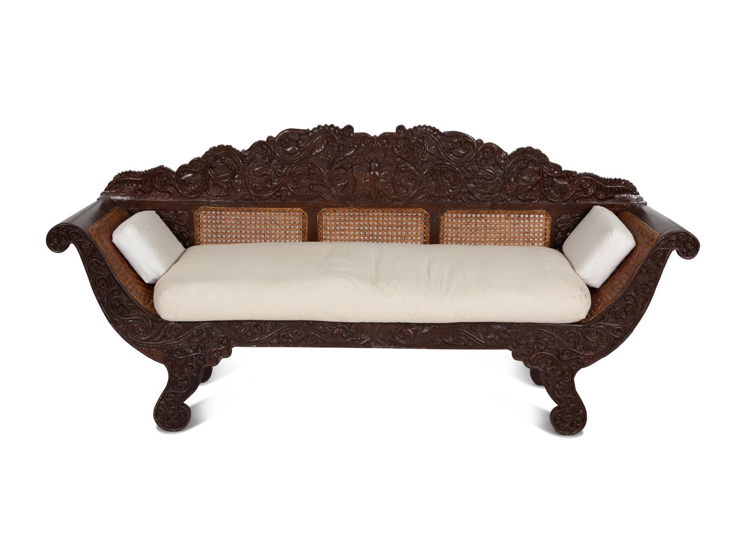 A British Colonial Carved Mahogany and Cane Work Settee