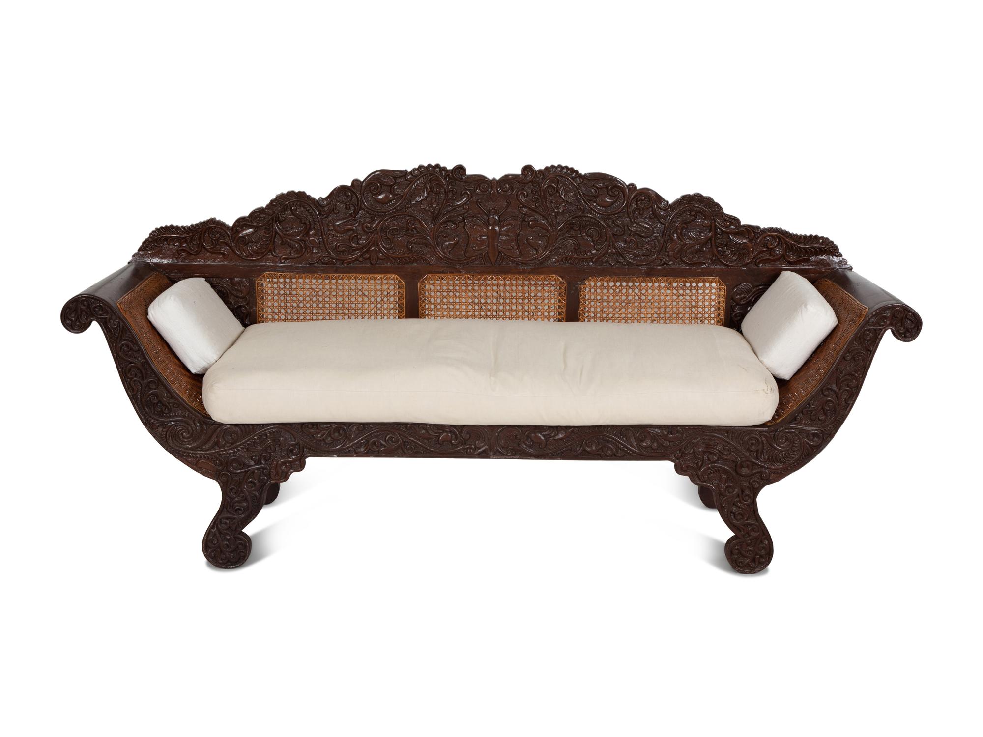 A British Colonial Carved Mahogany and Cane Work Settee