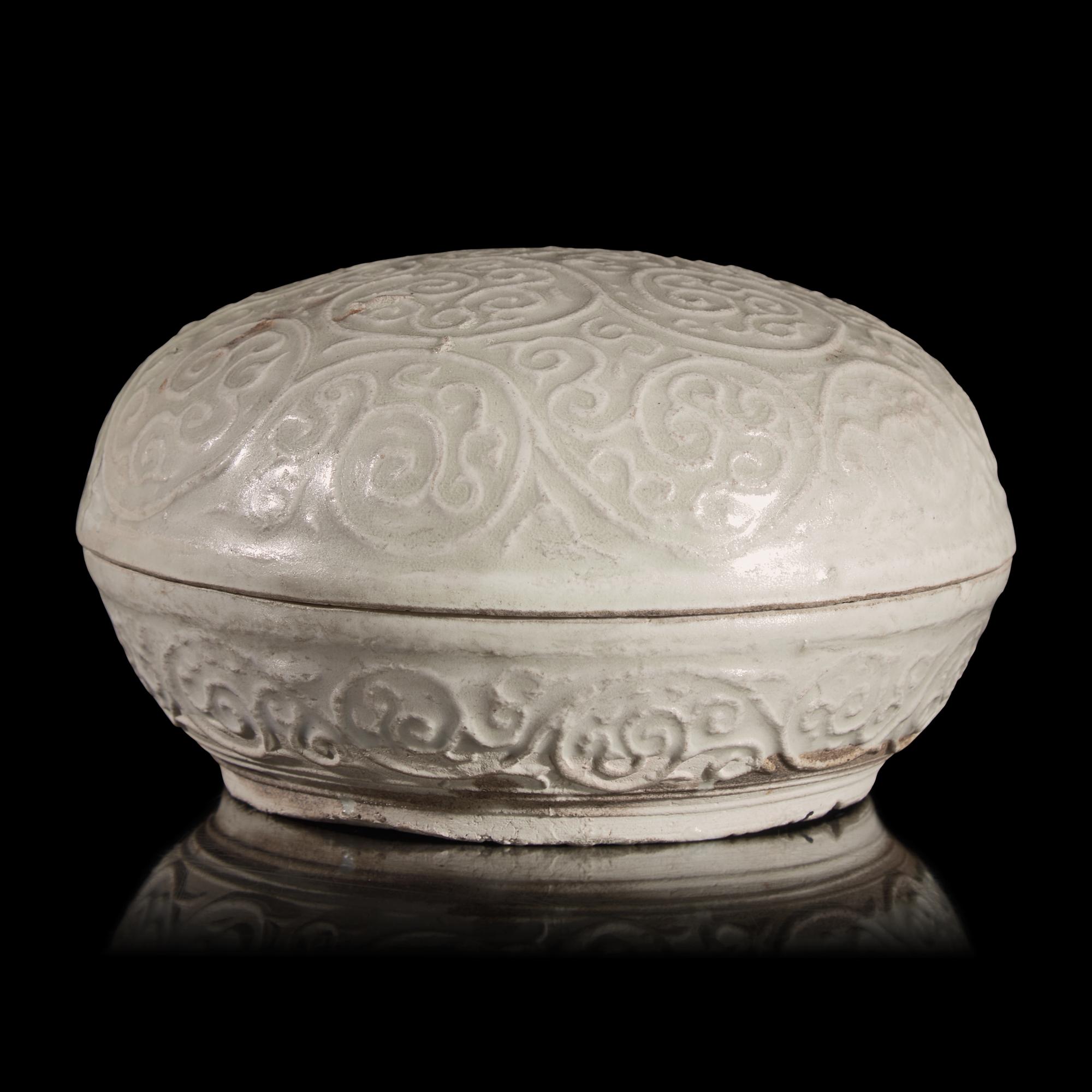 A Chinese Molded Dehua Porcelain Box and Cover, Song/Yuan Dynasty — 宋/元 德化白瓷卷草紋圓蓋盒
