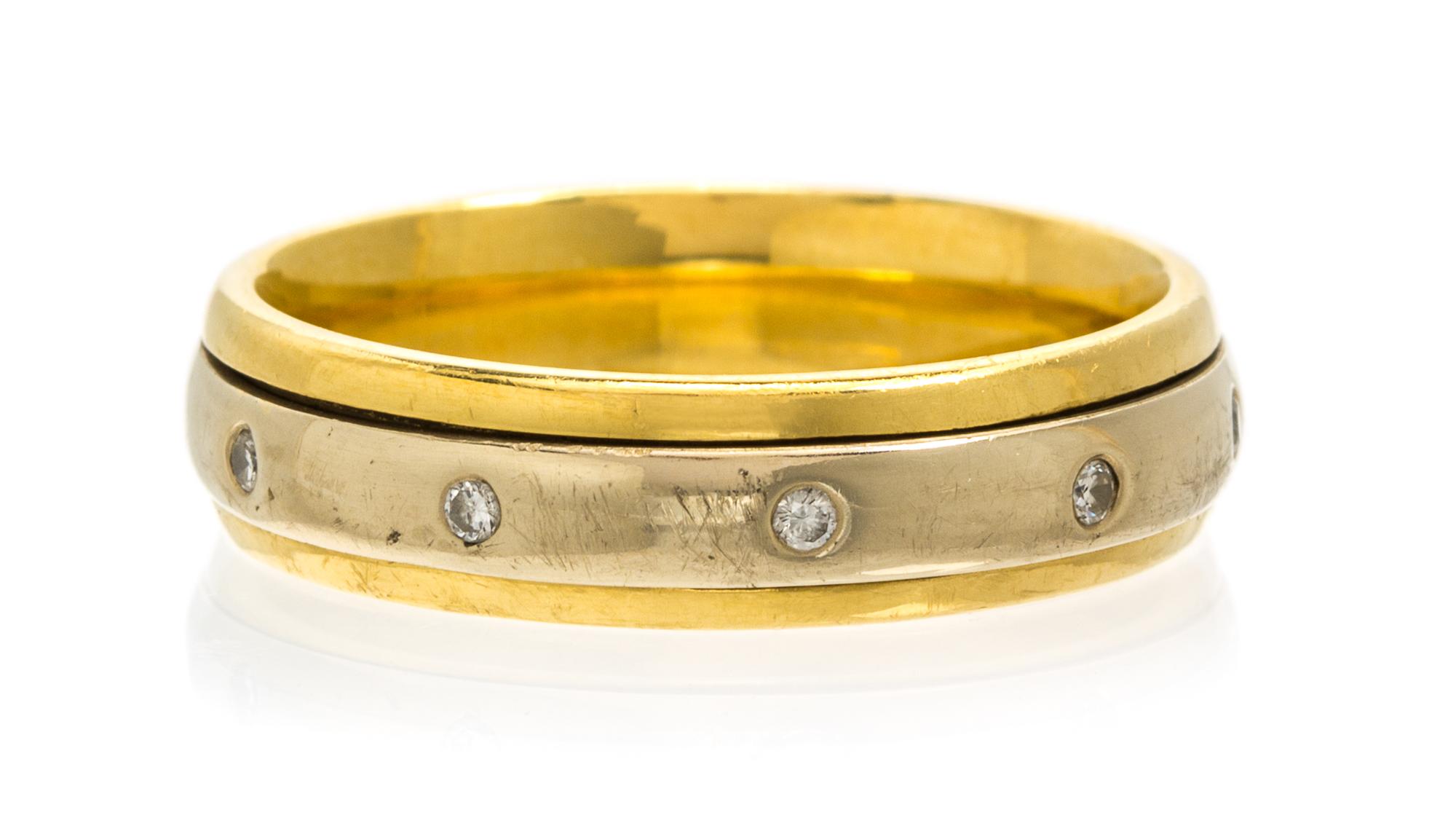 An 18 Karat Two Tone Gold and Diamond Rolling Ring, 6.80 dwts.