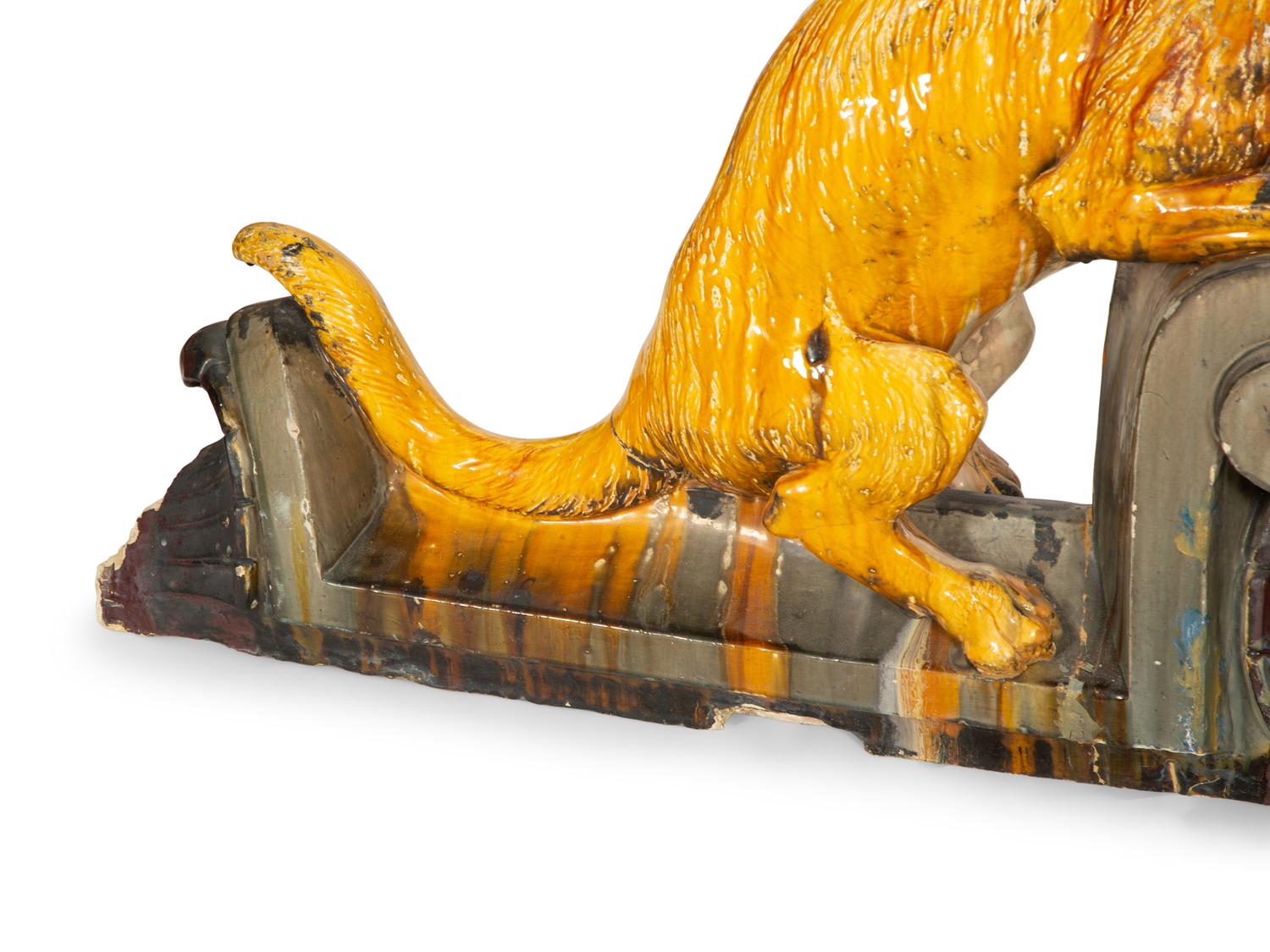 A Pair of Continental Glazed Terra Cotta Fox Roof Ornaments