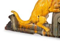 A Pair of Continental Glazed Terra Cotta Fox Roof Ornaments