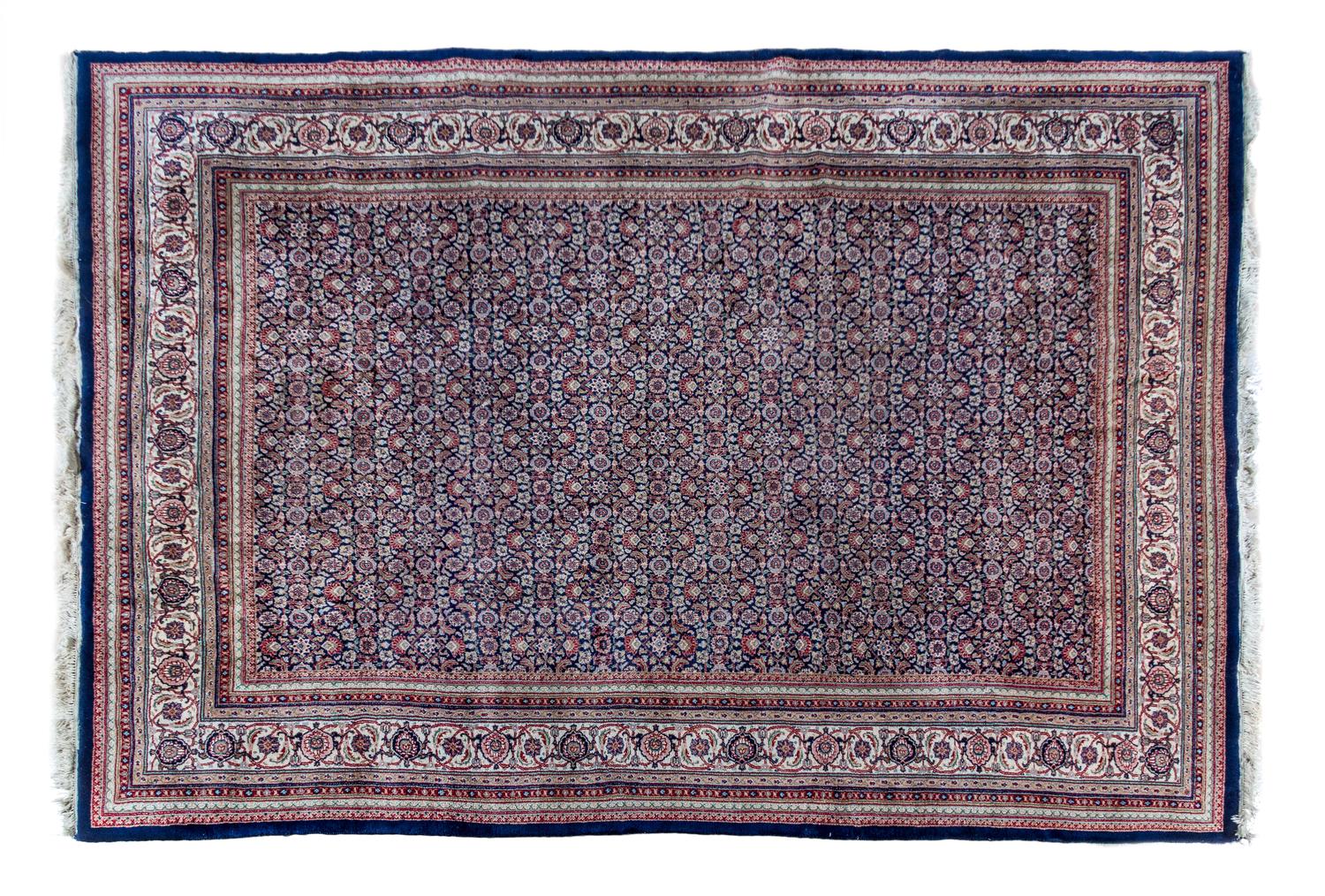 An Indo-Persian Wool Rug 8 feet 7 inches x 11 feet 4 inches.