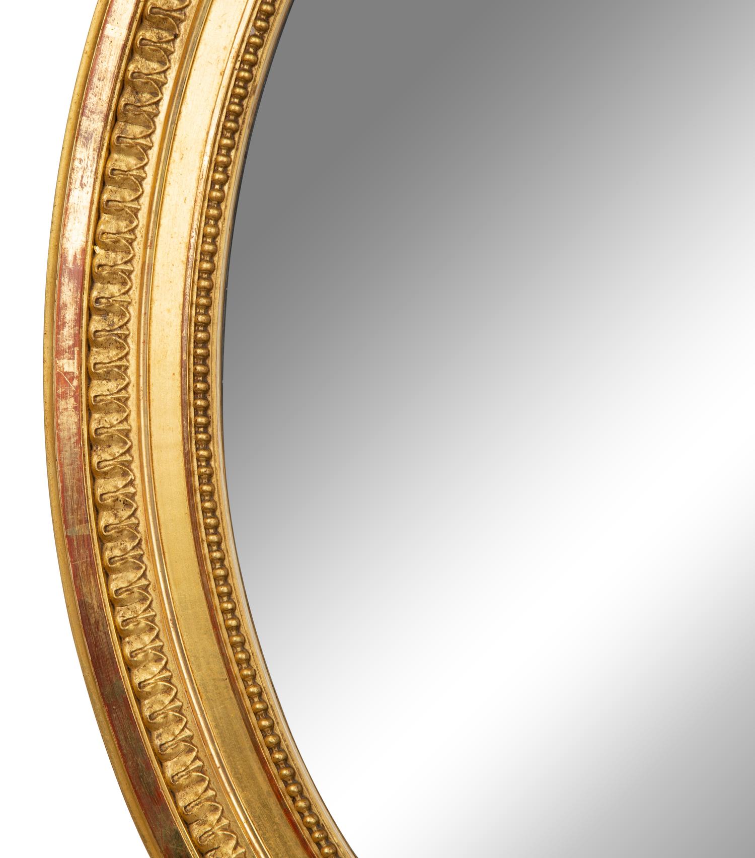 A Louis XV Style Giltwood Framed Oval Mirror — 19TH CENTURY