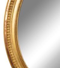 A Louis XV Style Giltwood Framed Oval Mirror — 19TH CENTURY