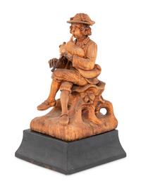 A Continental Carved Wood Statue of a Bagpipe Player