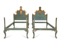 A Pair of Venetian Style Painted and Parcel Gilt Twin Beds
