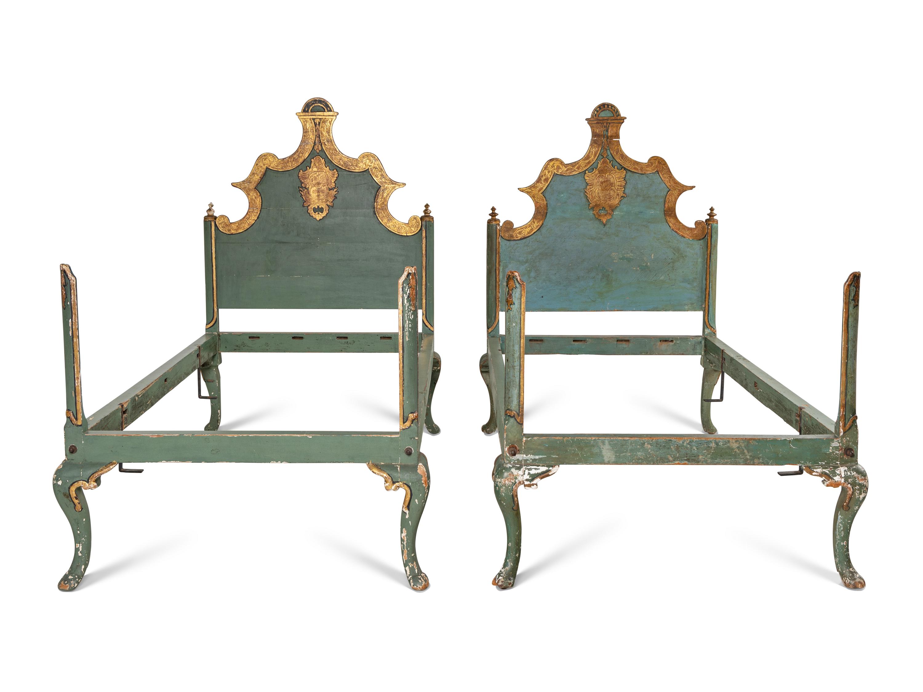 A Pair of Venetian Style Painted and Parcel Gilt Twin Beds