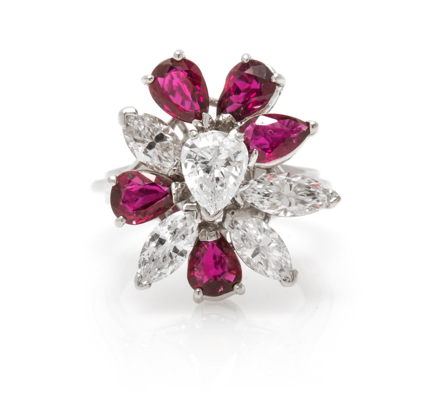 An 18 Karat White Gold, Diamond and Ruby Spray Ring, 4.20 dwts.