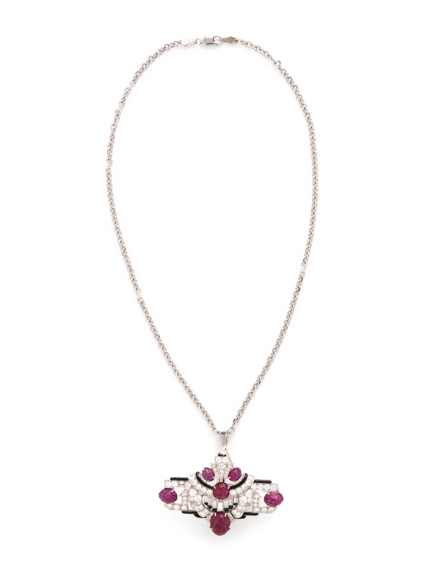 MAUBOUSSIN, ART DECO, CARVED RUBY, DIAMOND, AND BLACK ENAMEL BROOCH