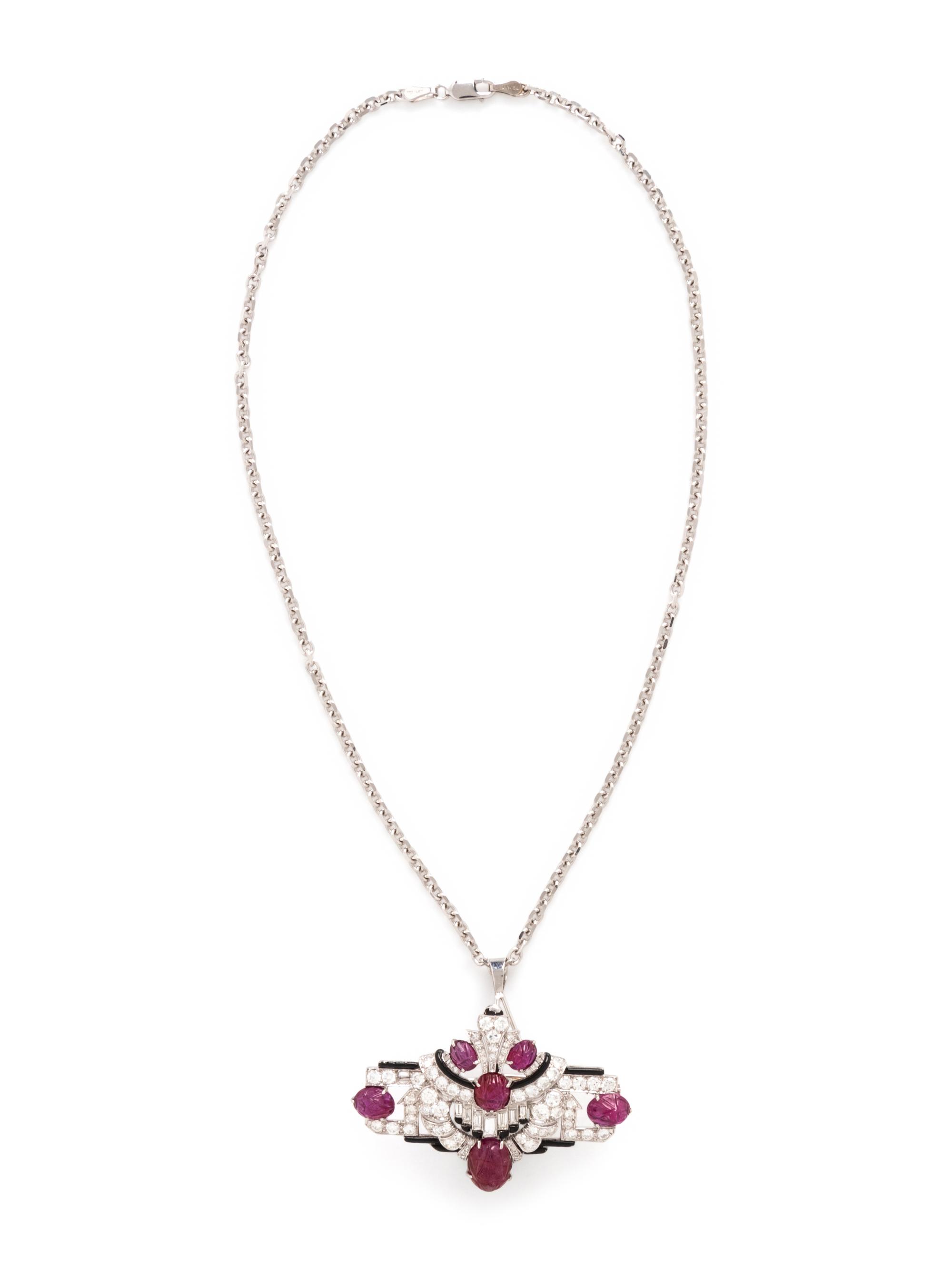 MAUBOUSSIN, ART DECO, CARVED RUBY, DIAMOND, AND BLACK ENAMEL BROOCH