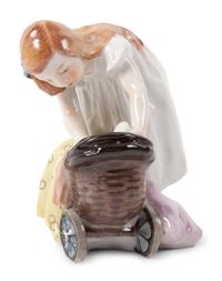 A Meissen Porcelain Figure of a Girl with a Doll Stroller, by Konrad Hentschel