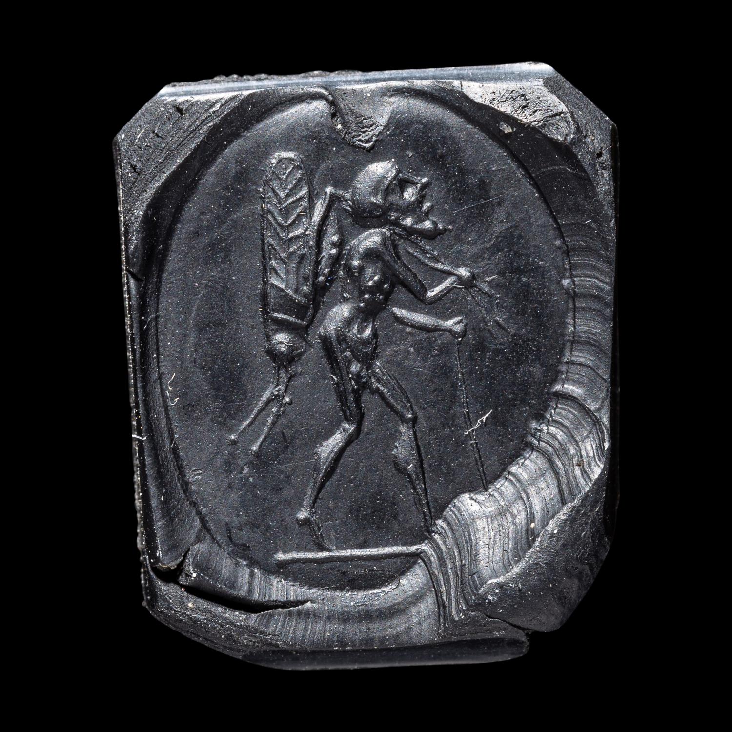 A Roman Sardonyx Ring Stone with a Pygmy and Locust