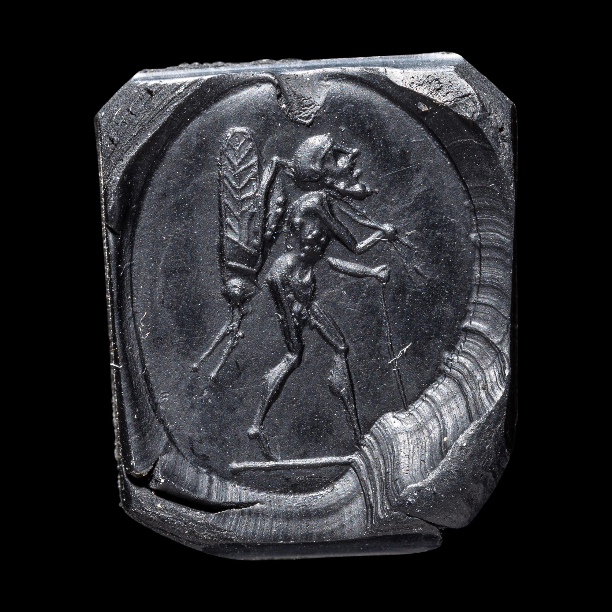 A Roman Sardonyx Ring Stone with a Pygmy and Locust