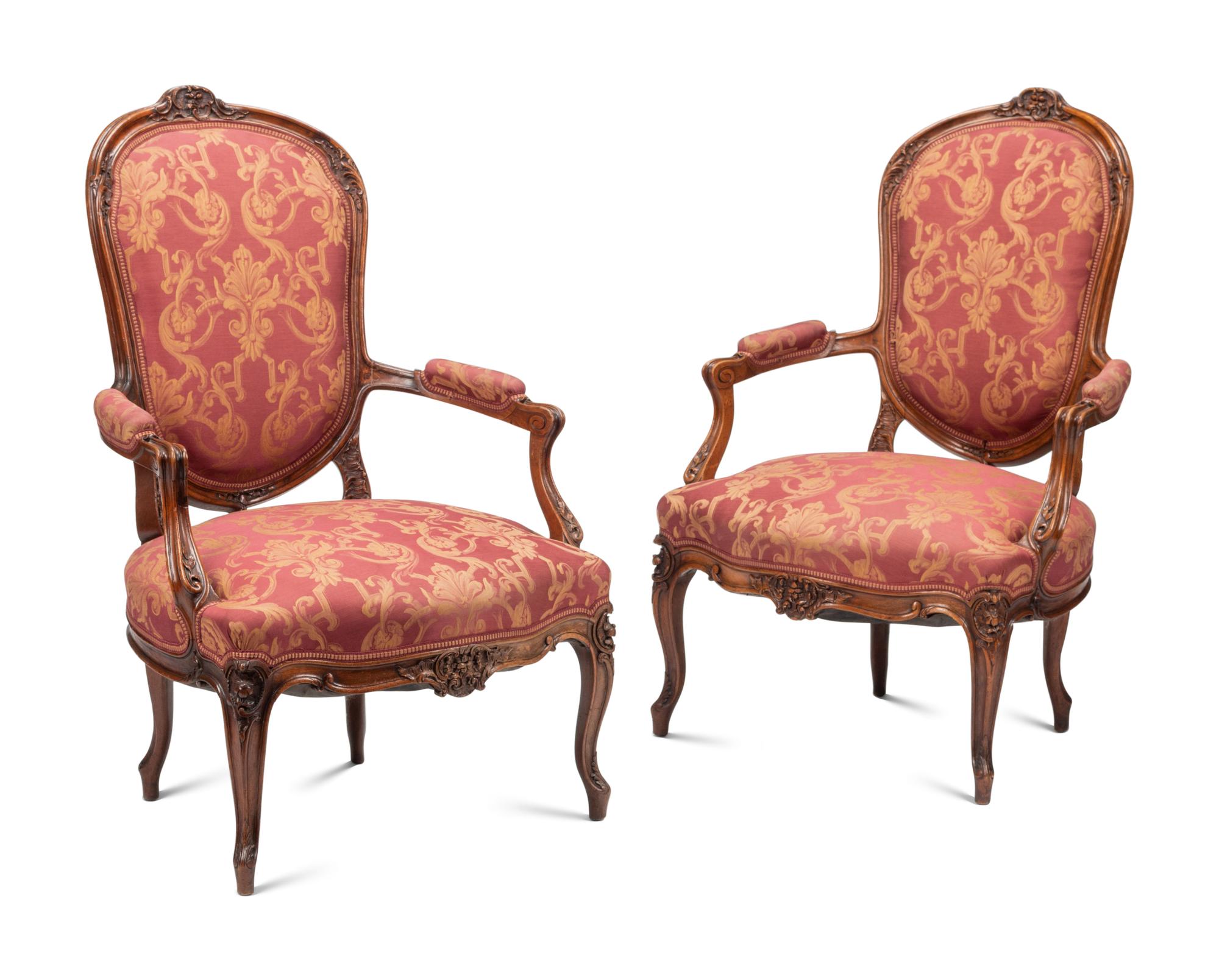 A Pair of Louis XV Style Carved Walnut Fauteuils