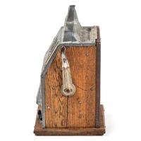 A Mills Novelty Co. 10 Cent Roman Head Slot Machine