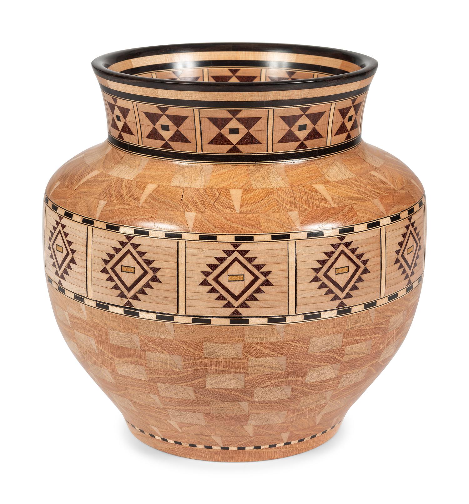 A Turned and Segmented Wood Vase in the style of Ray Allen