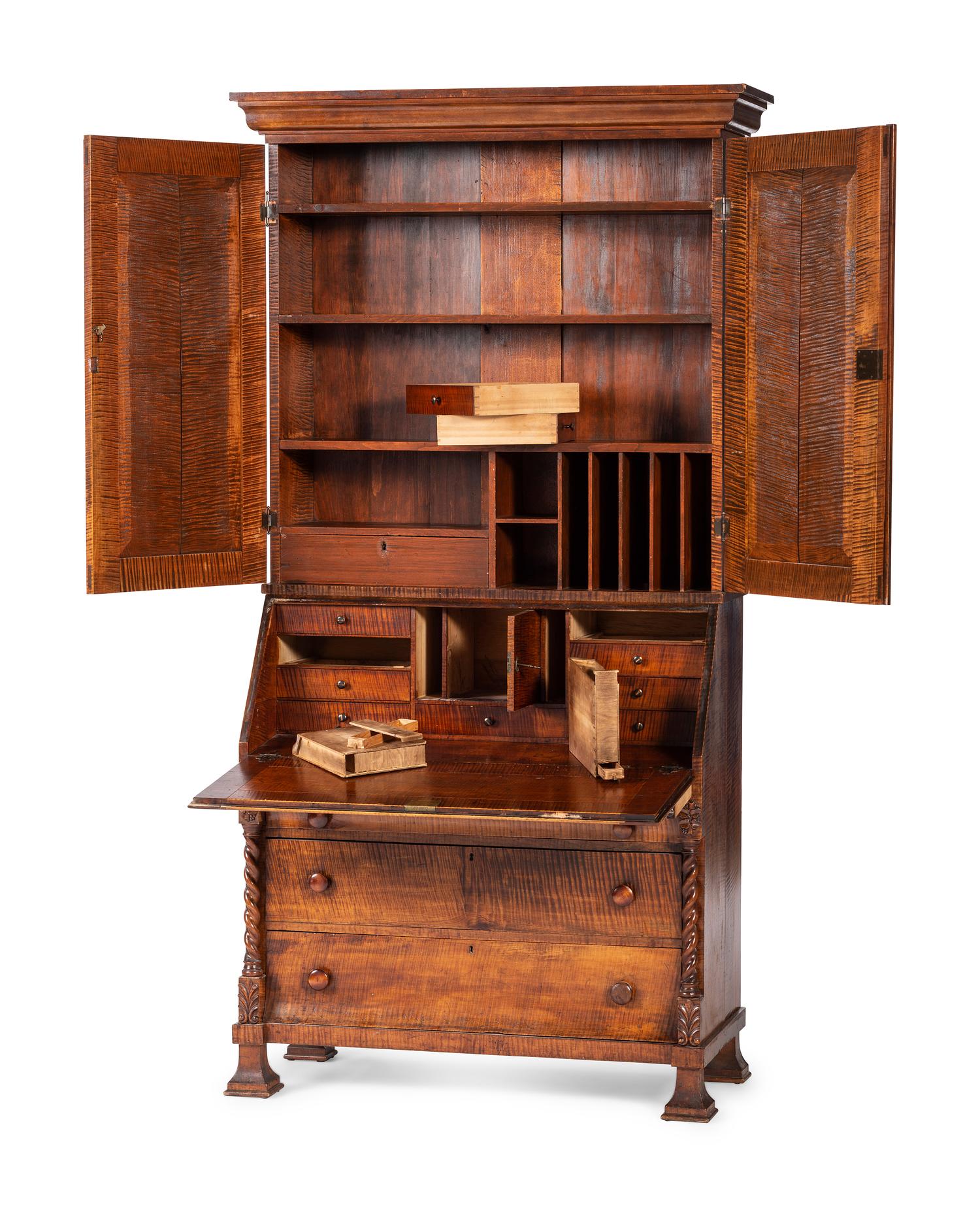 A Classical Style Carved and Highly Figured Tiger Maple Slant Front Desk