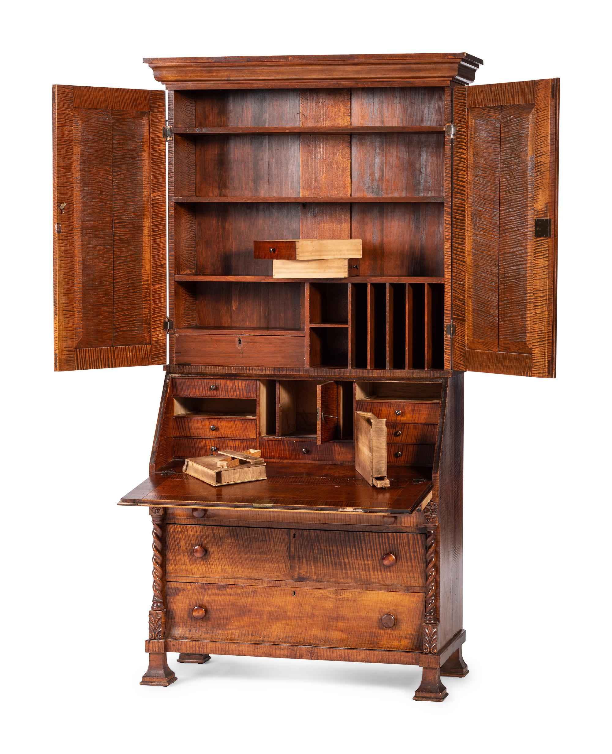 A Classical Style Carved and Highly Figured Tiger Maple Slant Front Desk