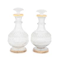 A Near Pair of George III Silver-Gilt Mounted Cut Glass Decanters