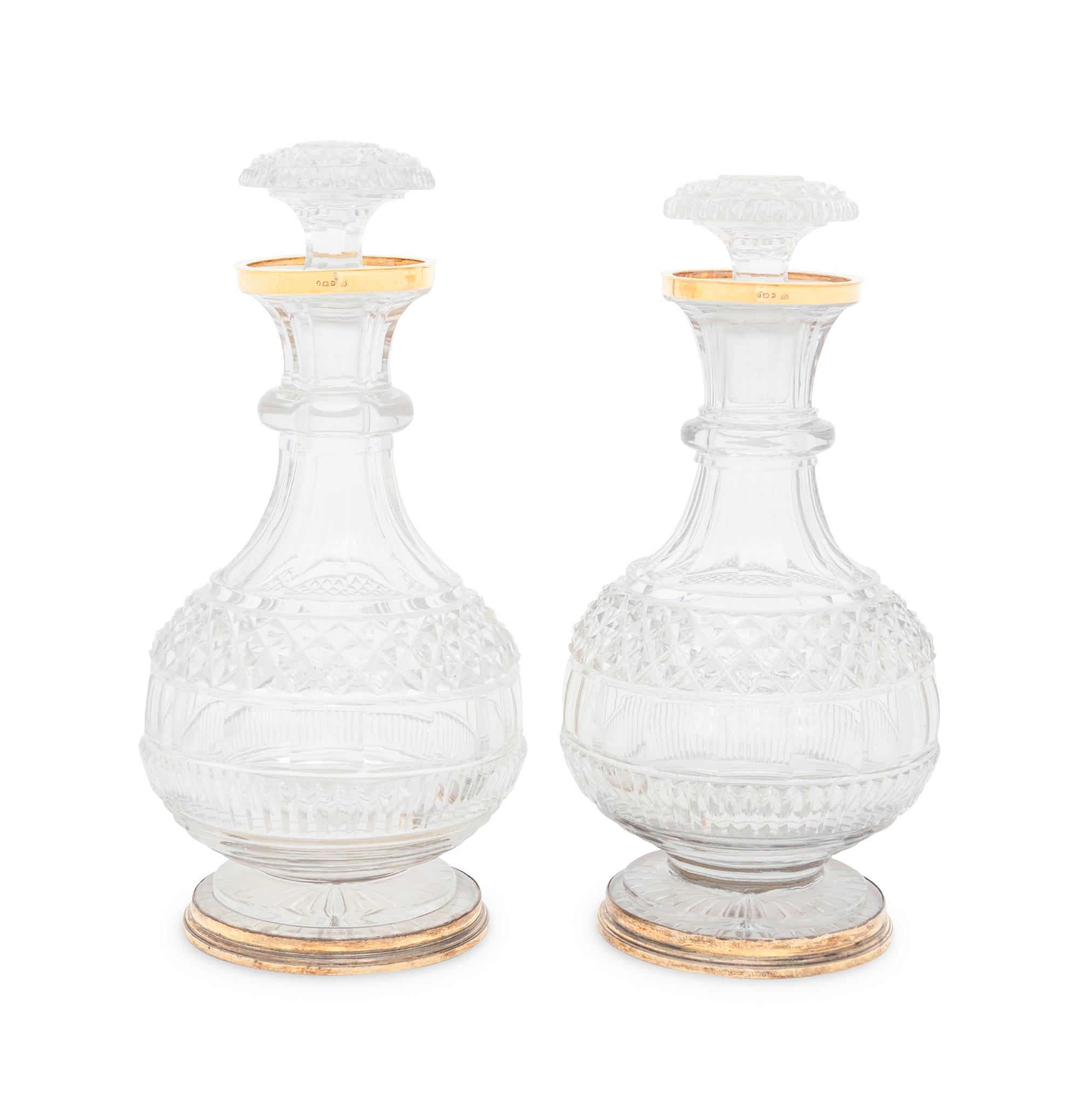 A Near Pair of George III Silver-Gilt Mounted Cut Glass Decanters